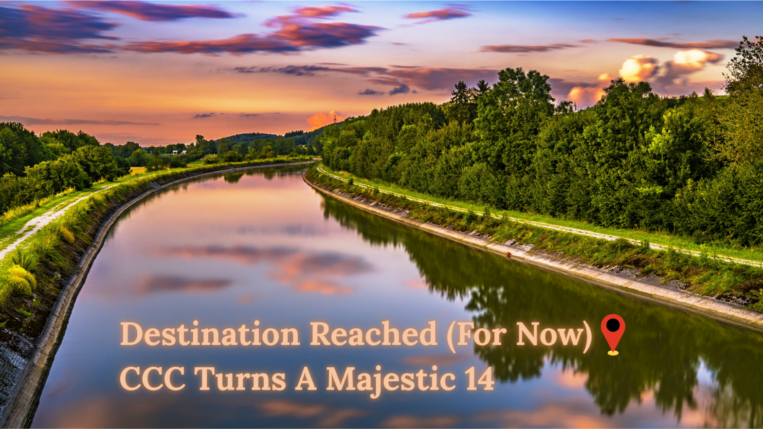 Destination Reached (For Now): CCC Turns A Majestic 14 Background: Clouds dot a pink sky over a river surrounded by forest during the golden hour
